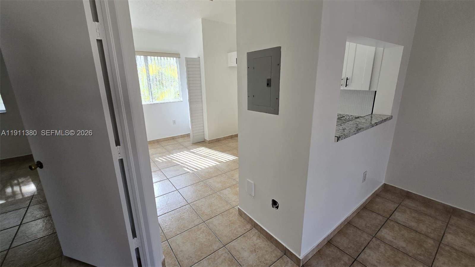 13120 Southwest 64th Terrace, Unit 1510 Miami, FL 33183 - Photo 20 of 25 a view of a hallway with windows and entryway