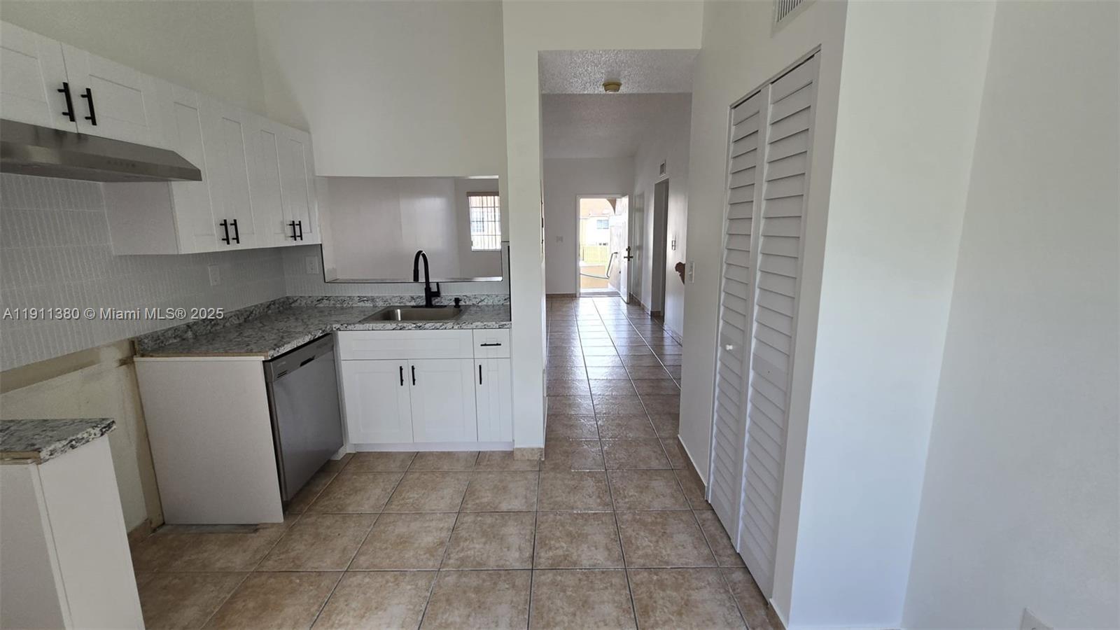 13120 Southwest 64th Terrace, Unit 1510 Miami, FL 33183 - Photo 21 of 24 a kitchen with a sink stove and cabinets
