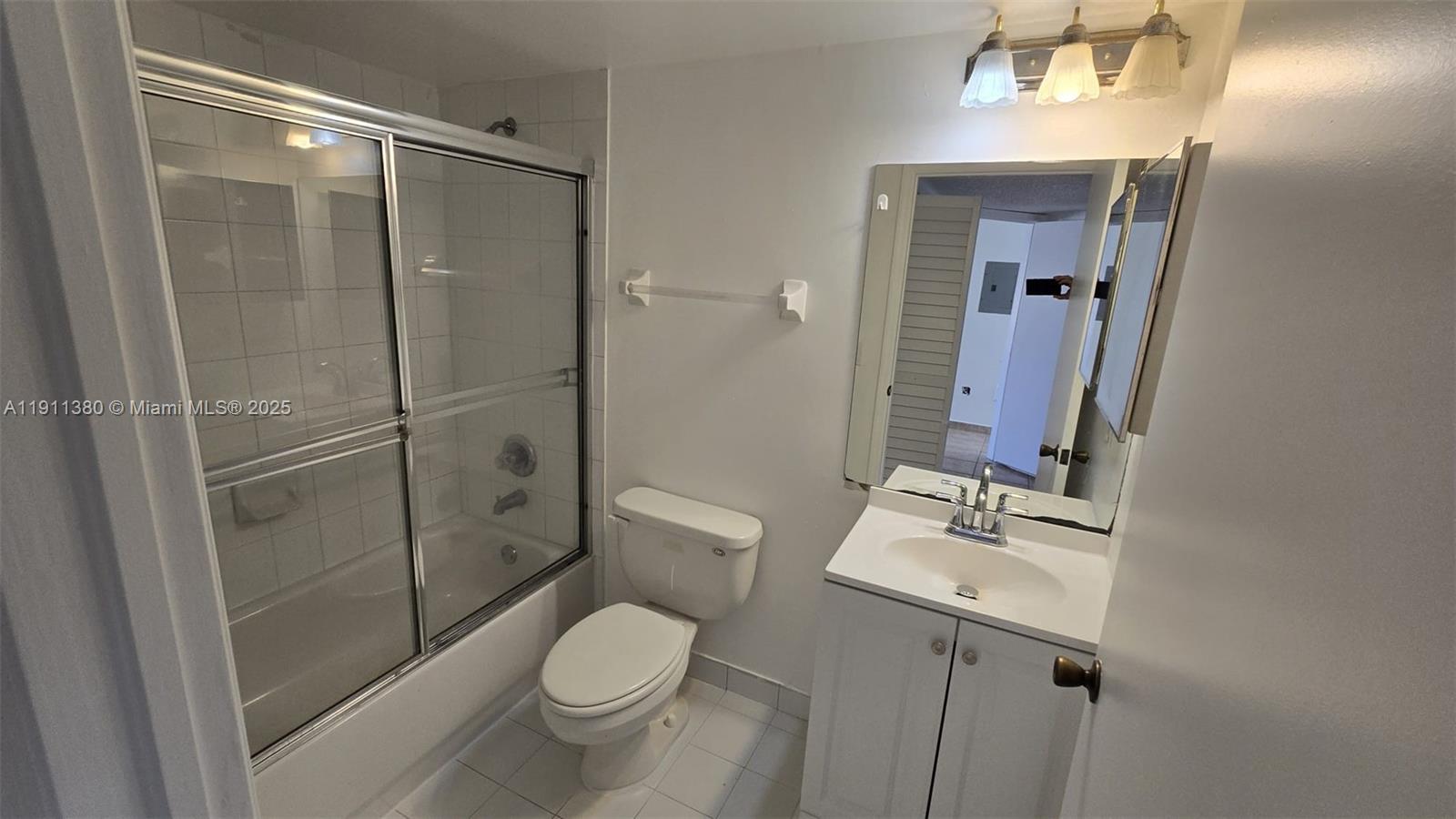 13120 Southwest 64th Terrace, Unit 1510 Miami, FL 33183 - Photo 23 of 24 a bathroom with a toilet a sink and shower