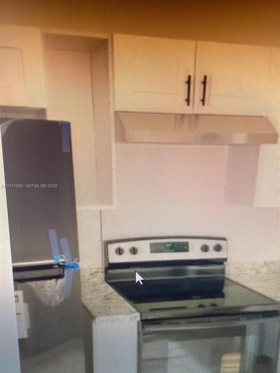 13120 Southwest 64th Terrace, Unit 1510 Miami, FL 33183 - Photo 25 of 25 a close view of a sink a counter and appliances in the kitchen