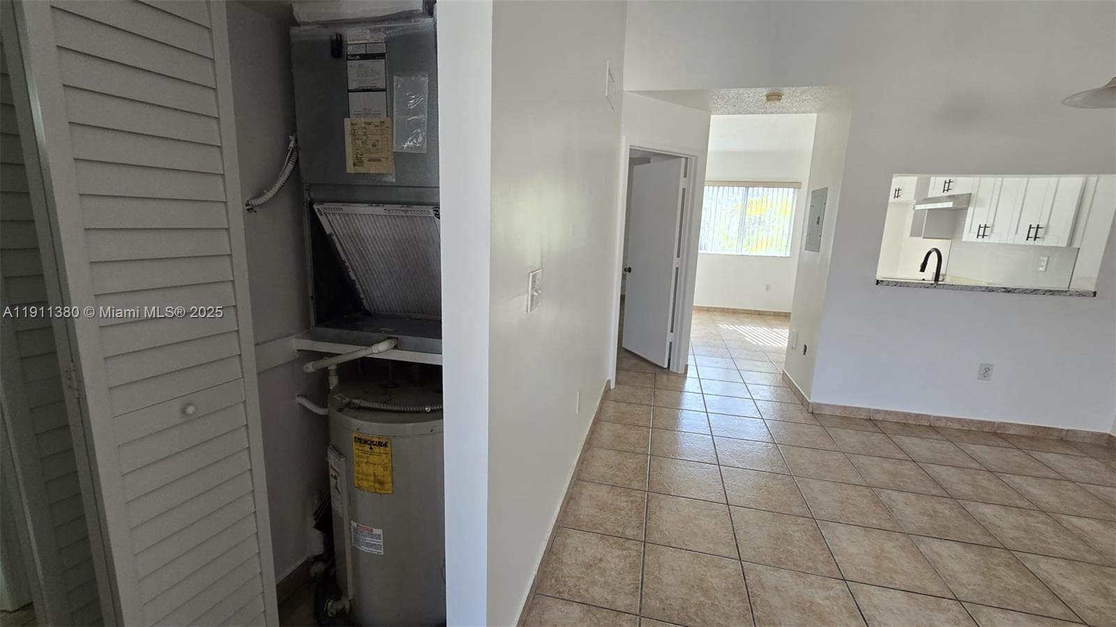 13120 Southwest 64th Terrace, Unit 1510 Miami, FL 33183 - Photo 5 of 24 a view of a hallway and closet with a wooden floor