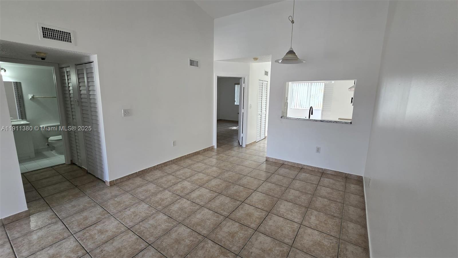13120 Southwest 64th Terrace, Unit 1510 Miami, FL 33183 - Photo 6 of 24 a view of an empty room and window