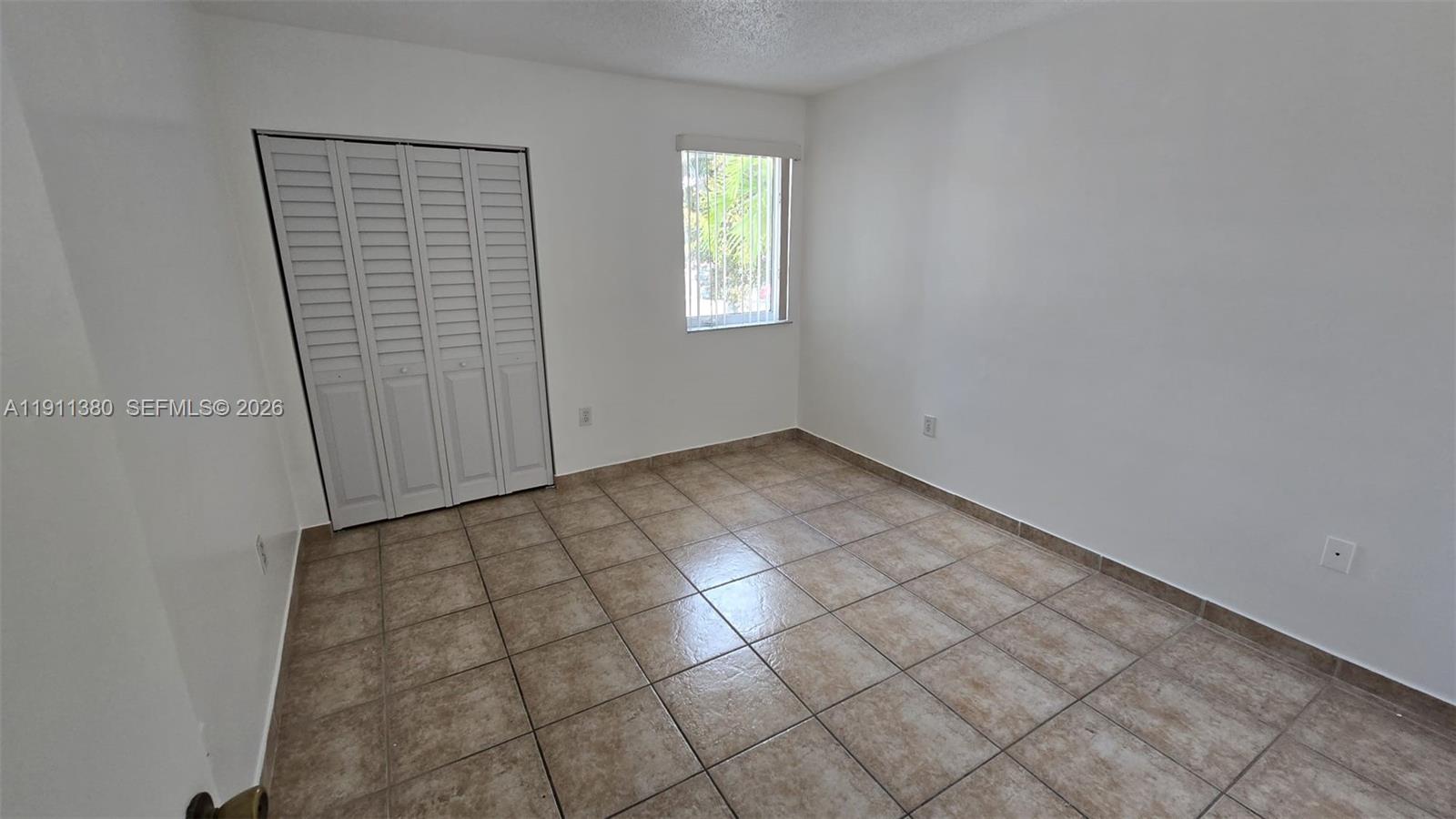 13120 Southwest 64th Terrace, Unit 1510 Miami, FL 33183 - Photo 8 of 25 an empty room with windows