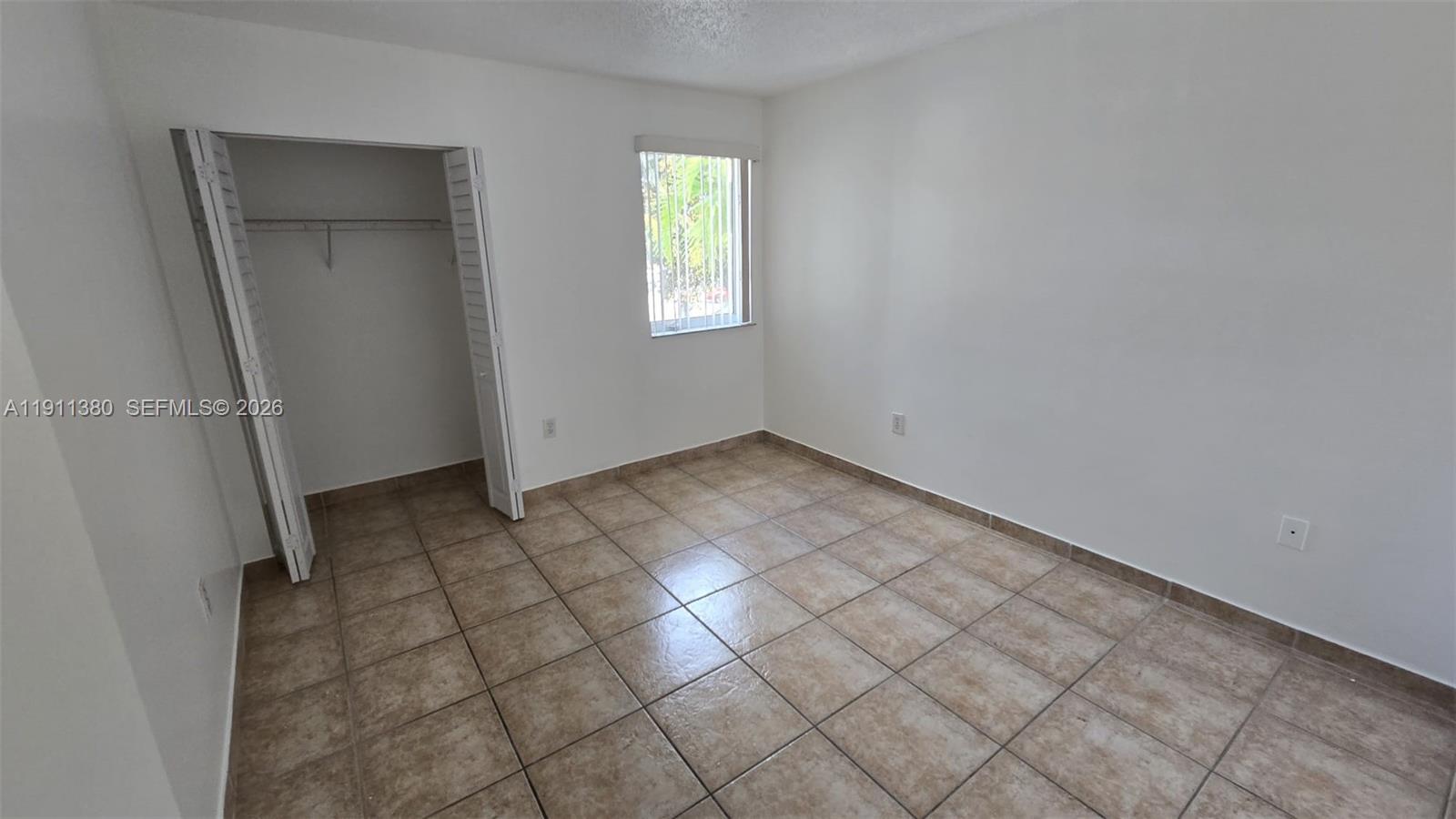 13120 Southwest 64th Terrace, Unit 1510 Miami, FL 33183 - Photo 10 of 25 an empty room with windows