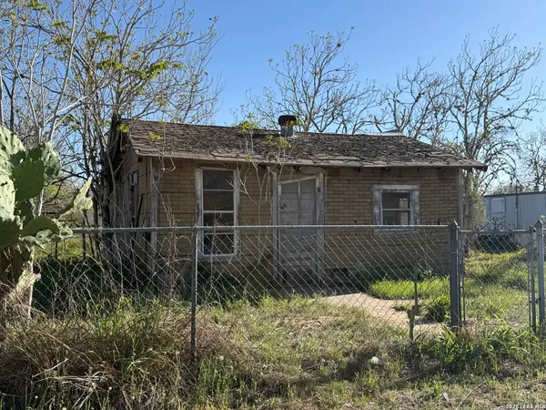 a side view of a house with a yard