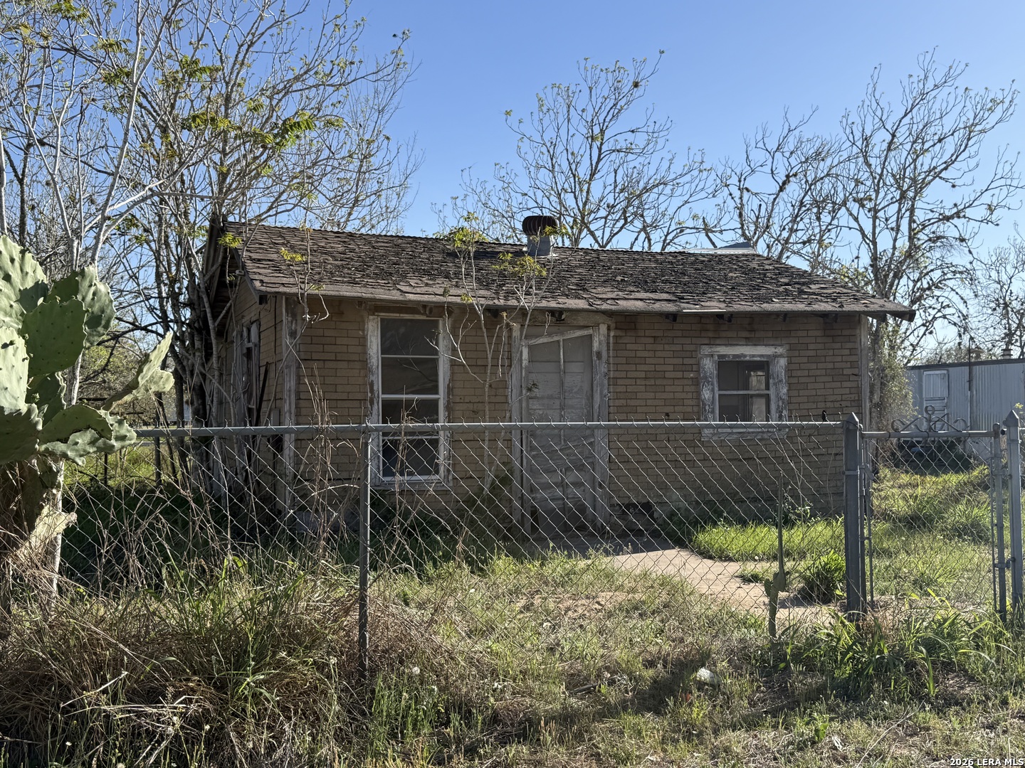 a side view of a house with a yard