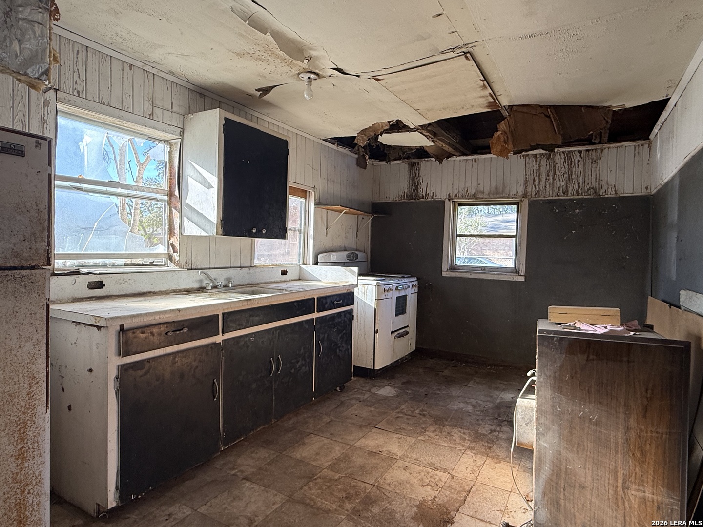 732 Trade Street Pleasanton, TX 78064 - Photo 3 of 13 a kitchen with a sink appliances cabinets and a window