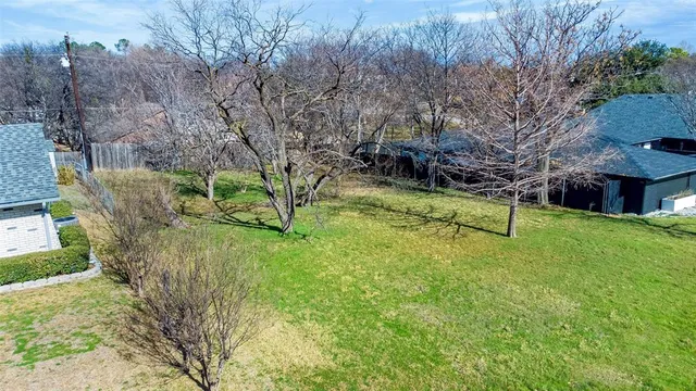 a view of a yard with large trees