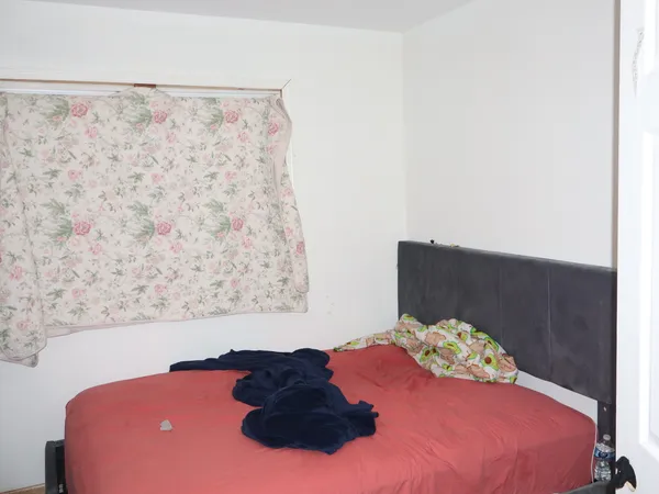 a bedroom with a bed and a wall painting