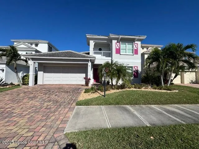 a front view of a house with a yard and a garage