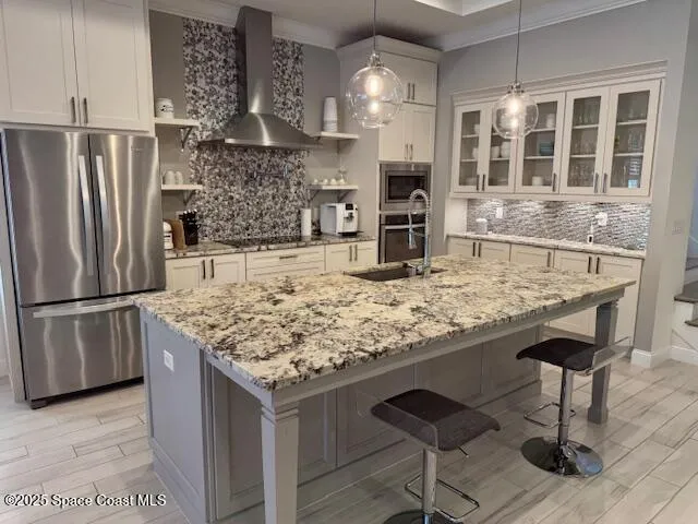 a kitchen with kitchen island granite countertop a oven a refrigerator and wooden cabinets