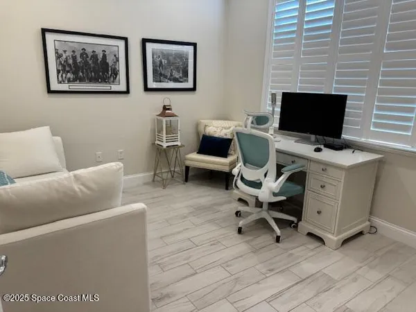 a view of a livingroom with workspace and a couch