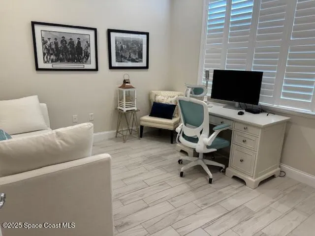 a view of a livingroom with workspace and a couch