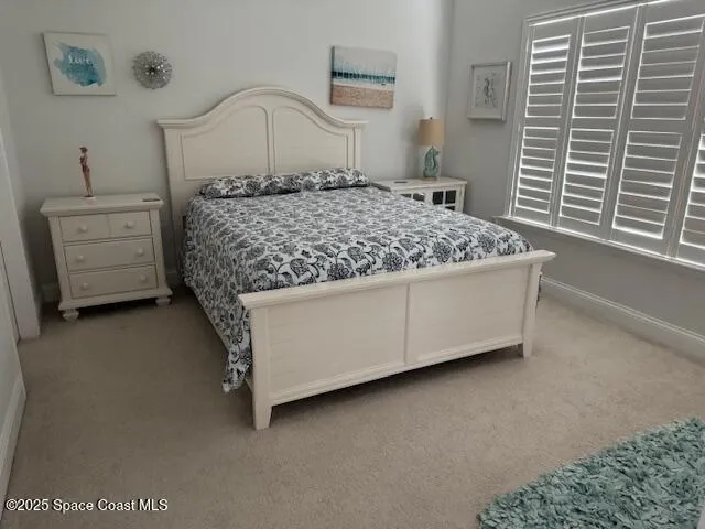 a bedroom with a bed dresser and a window