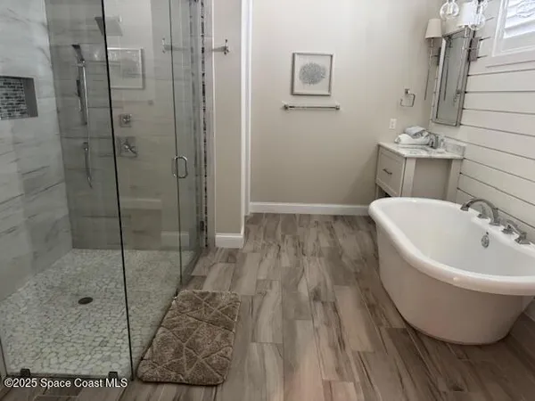 a bathroom with a bathtub and shower
