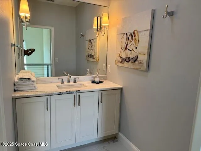 a bathroom with a granite countertop sink a mirror and a
