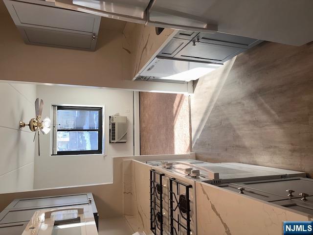 873 Main Street, Unit 2E Hackensack, NJ 07601 - Photo 4 of 23 a kitchen with stainless steel appliances a stove a microwave a sink a refrigerator and a stove