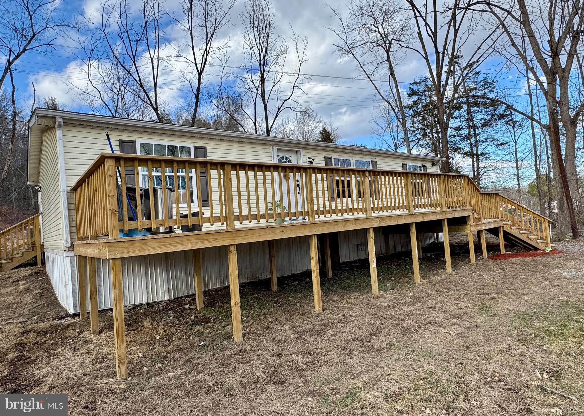 73 Mill Gap Road Brandywine, WV 26802 - Photo 2 of 35 a view of a house with a wooden deck and a trees