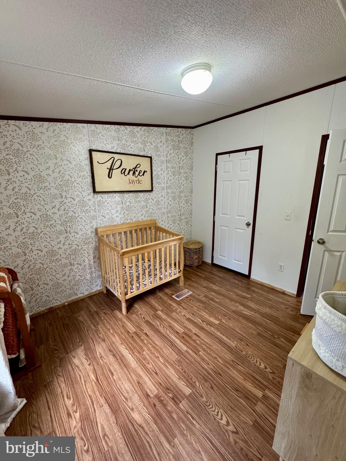 73 Mill Gap Road Brandywine, WV 26802 - Photo 25 of 35 a view of an empty room with wooden floor and a ceiling fan