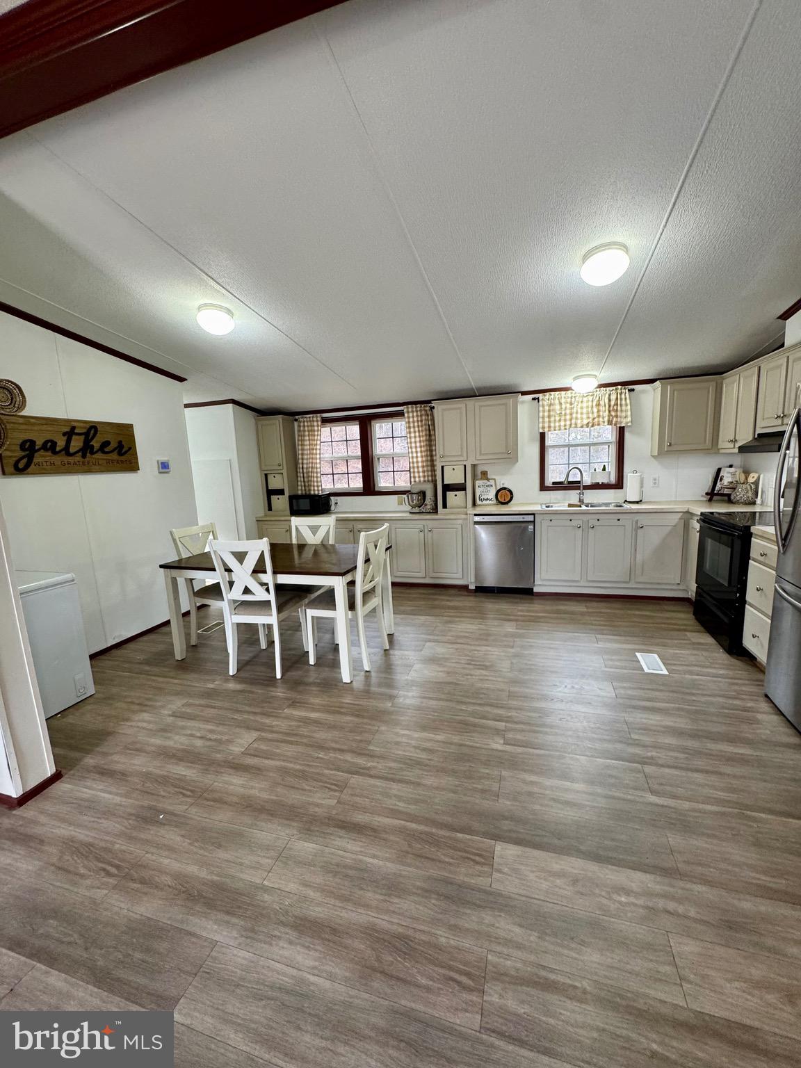 73 Mill Gap Road Brandywine, WV 26802 - Photo 8 of 35 a large white kitchen with lots of counter space and stainless steel appliances