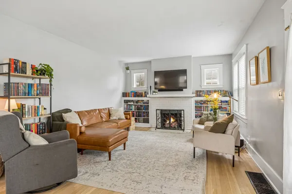 a living room with furniture a flat screen tv and a fireplace