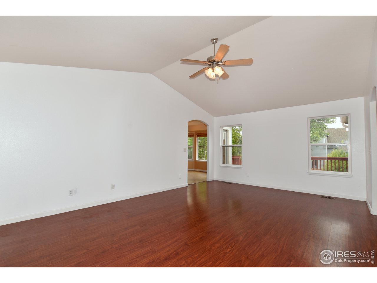924 Cliffrose Way Severance, CO 80550 - Photo 12 of 40 a view of an empty room with wooden floor and window