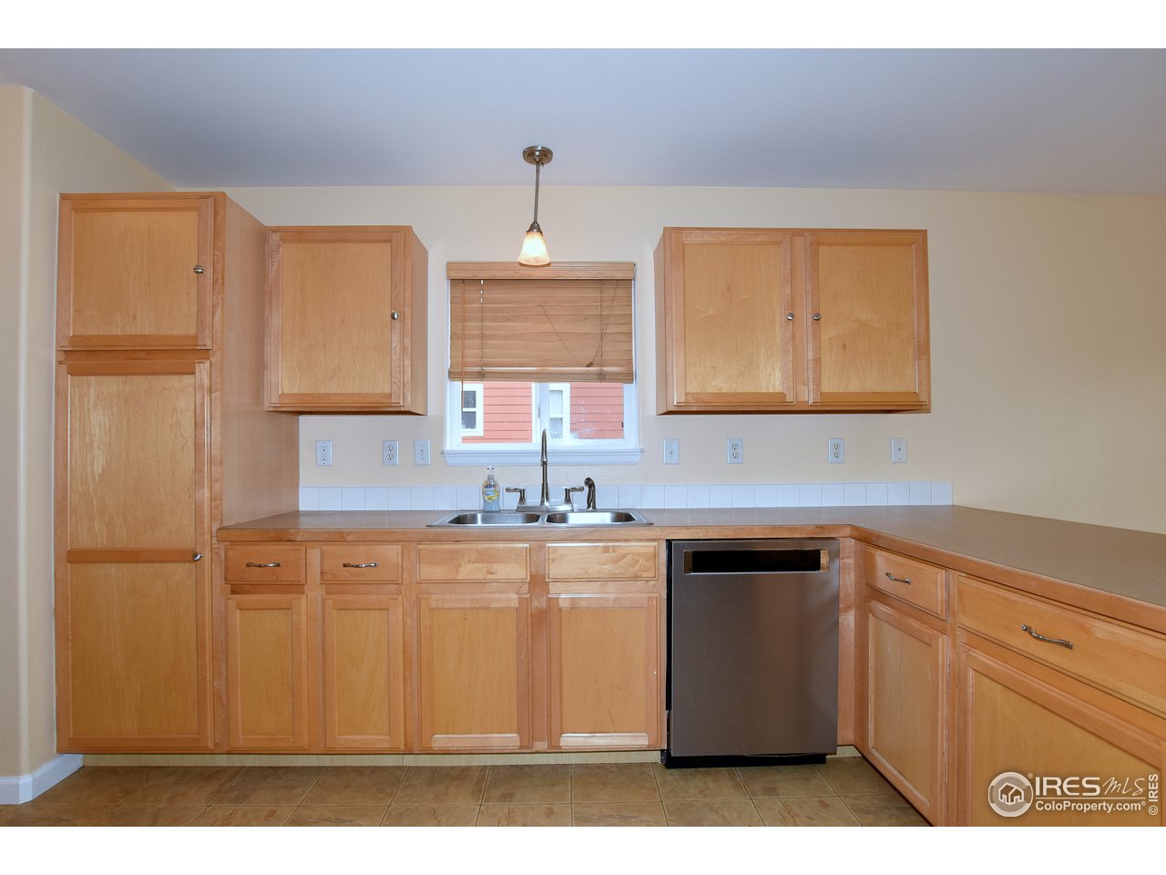 924 Cliffrose Way Severance, CO 80550 - Photo 16 of 40 a kitchen with a sink a stove and cabinets
