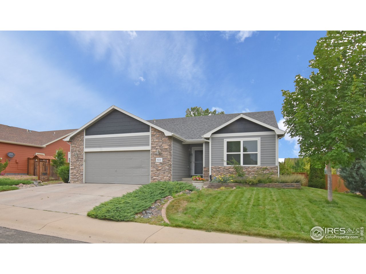 924 Cliffrose Way Severance, CO 80550 - Photo 2 of 40 a front view of a house with a yard