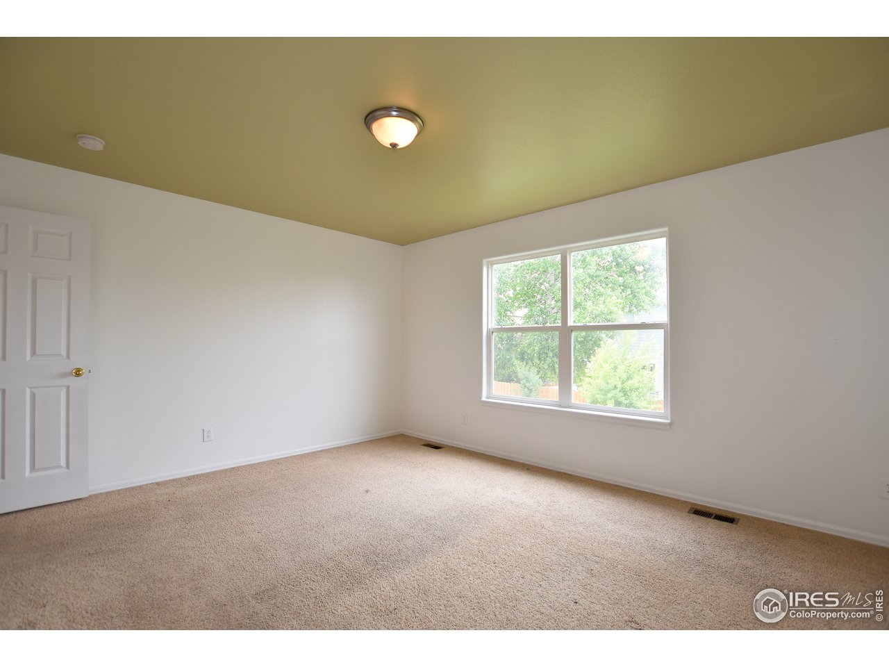 924 Cliffrose Way Severance, CO 80550 - Photo 21 of 40 a view of an empty room with a window