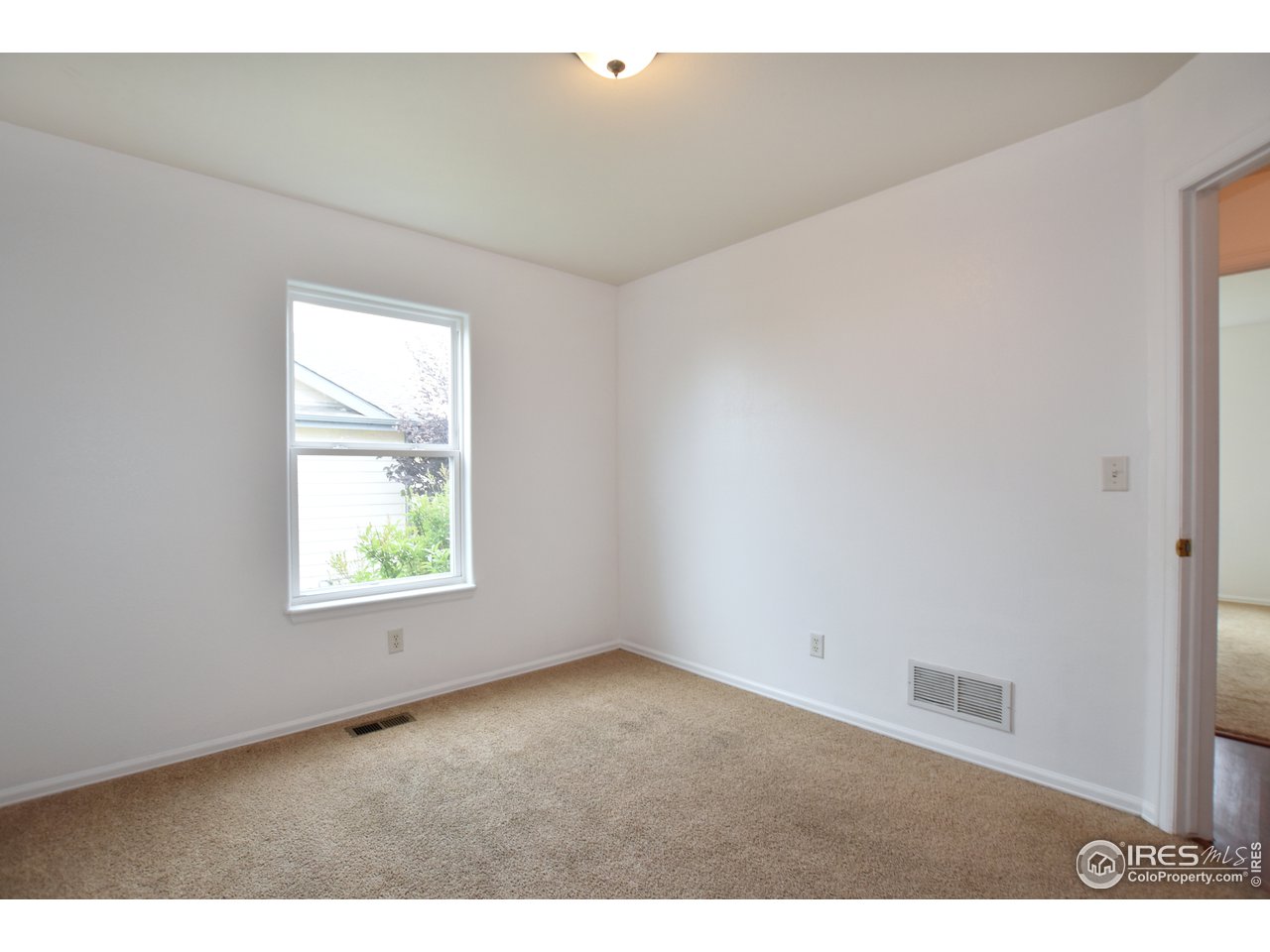 924 Cliffrose Way Severance, CO 80550 - Photo 28 of 40 an empty room with windows