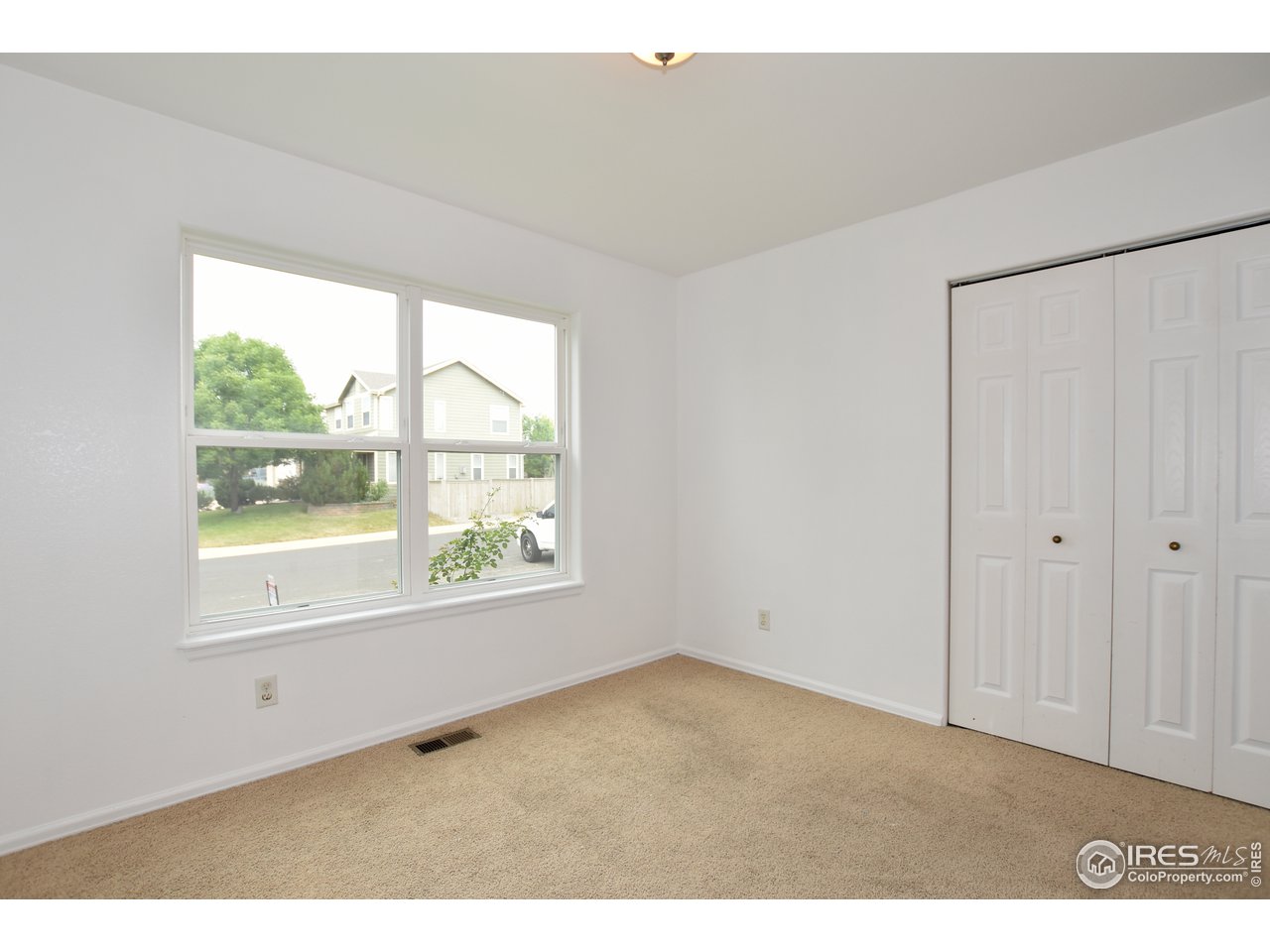 924 Cliffrose Way Severance, CO 80550 - Photo 33 of 40 a view of an empty room with a window