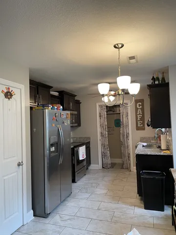 a view of a kitchen counter space and stainless steel appliances