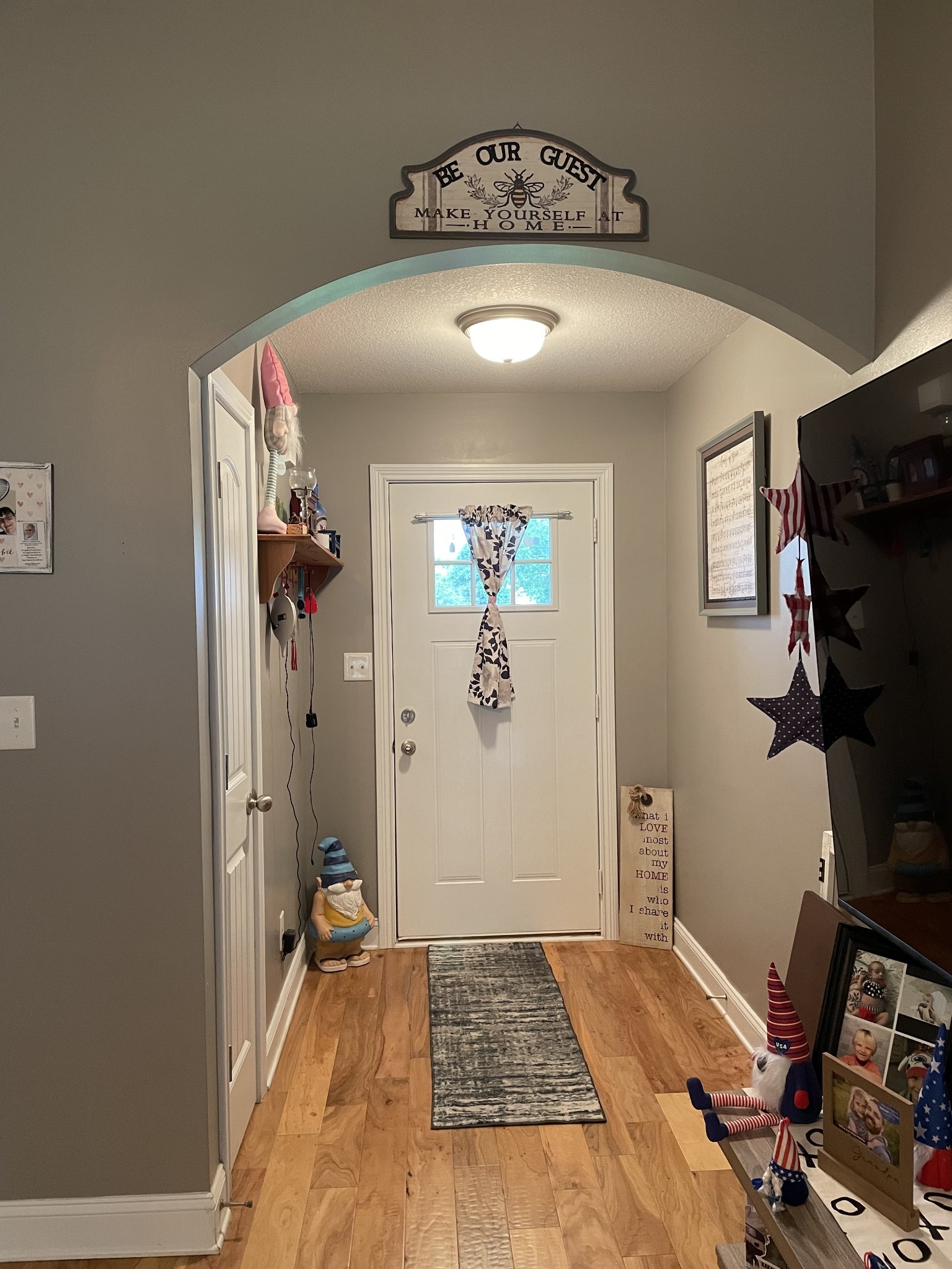 85 Good Hope Cemetery Road Oak Grove, KY 42262 - Photo 9 of 46 a view of a hallway to a livingroom with wooden floor and a window