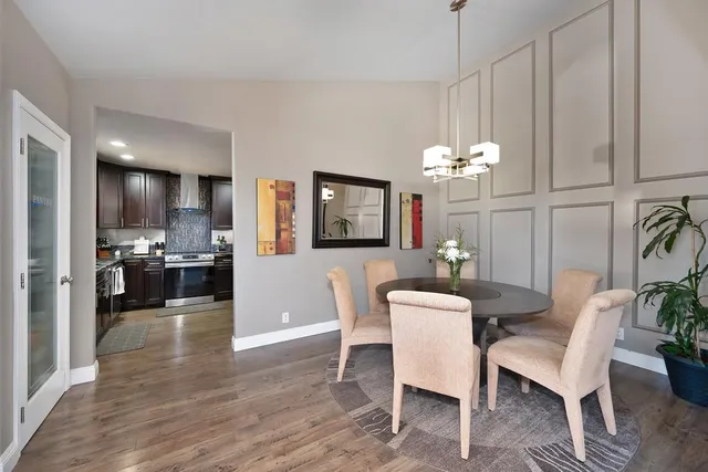 a living room with furniture large window and flat screen tv