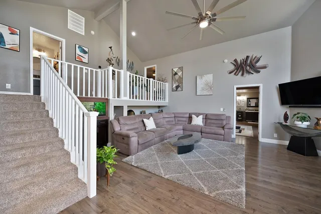 a bedroom with a large bed and a chandelier