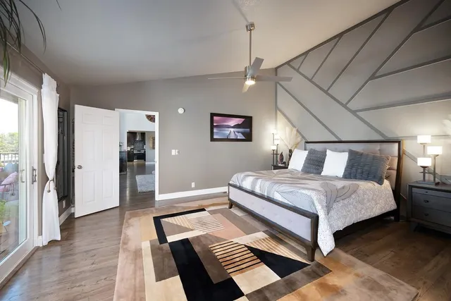 a spacious bedroom with a bed and ceiling fan