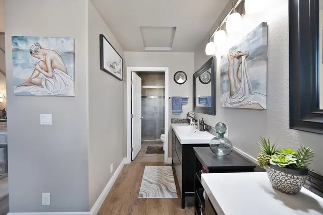 a kitchen with stainless steel appliances granite countertop a refrigerator a sink a stove and cabinets