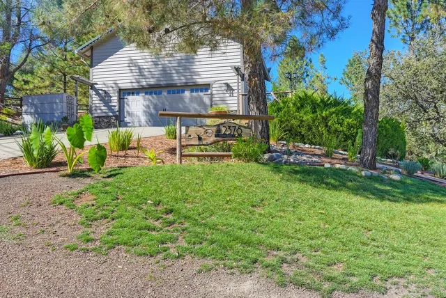 a view of a house with backyard and sitting area