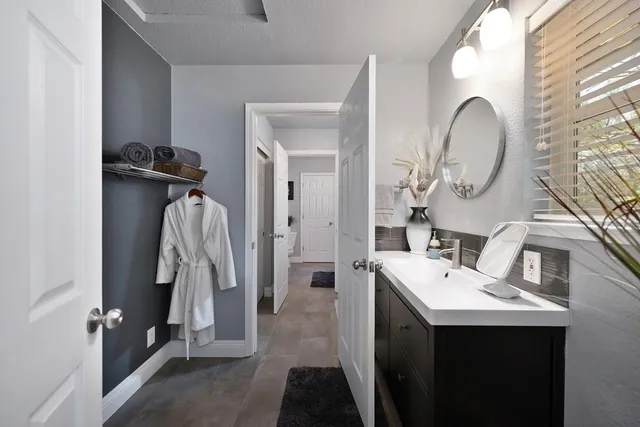 a view of a patio with couches and table and chairs and potted plants