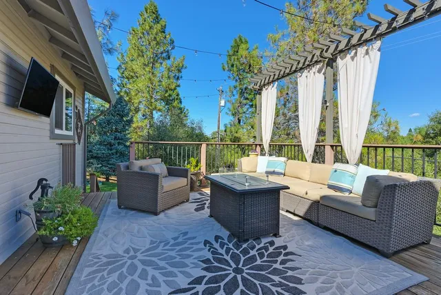an aerial view of a house with outdoor space and trees