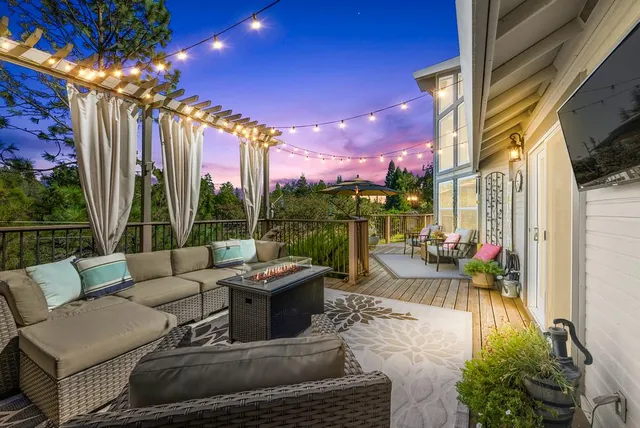 a view of house with yard and outdoor seating