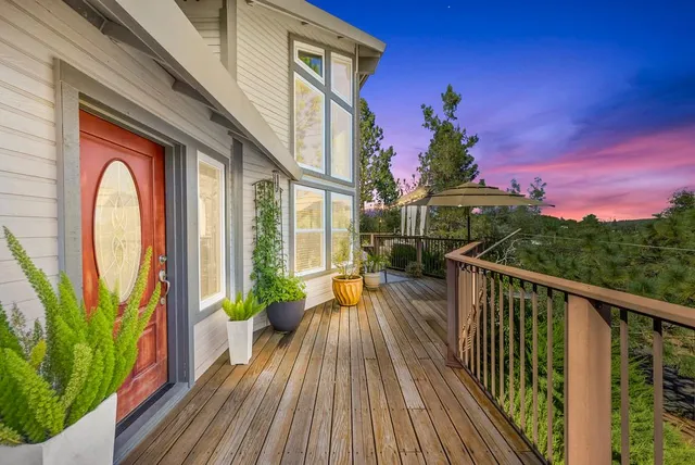 a vase with flowers on a table with front door
