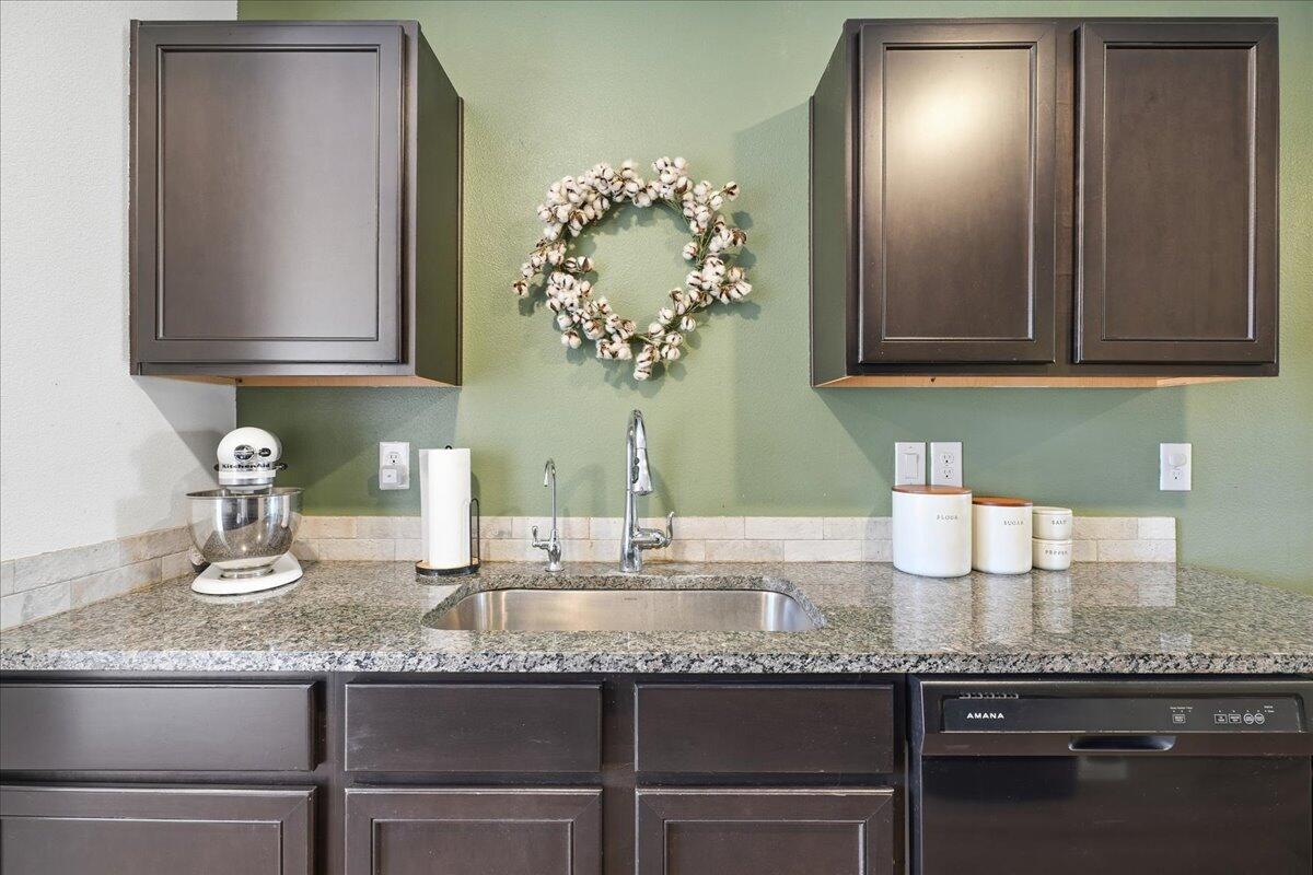 13804 Paris Avenue Lubbock, TX 79423 - Photo 11 of 28 a kitchen with granite countertop a sink and cabinets