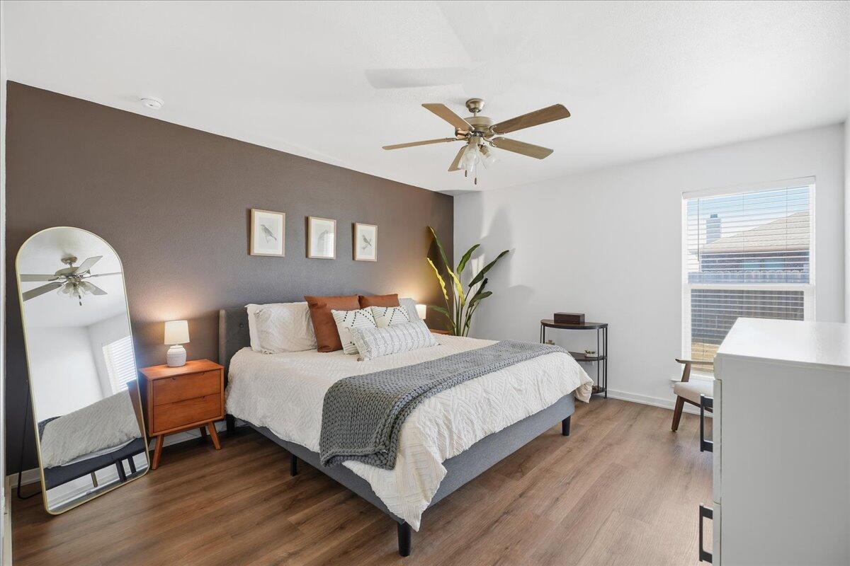 13804 Paris Avenue Lubbock, TX 79423 - Photo 12 of 28 a bedroom with a bed and a chandelier