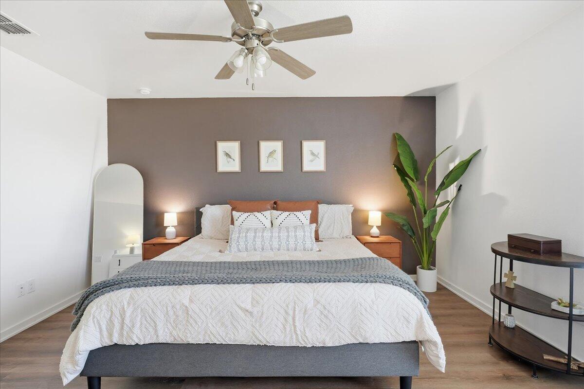 13804 Paris Avenue Lubbock, TX 79423 - Photo 13 of 28 a bedroom with a bed and a chandelier