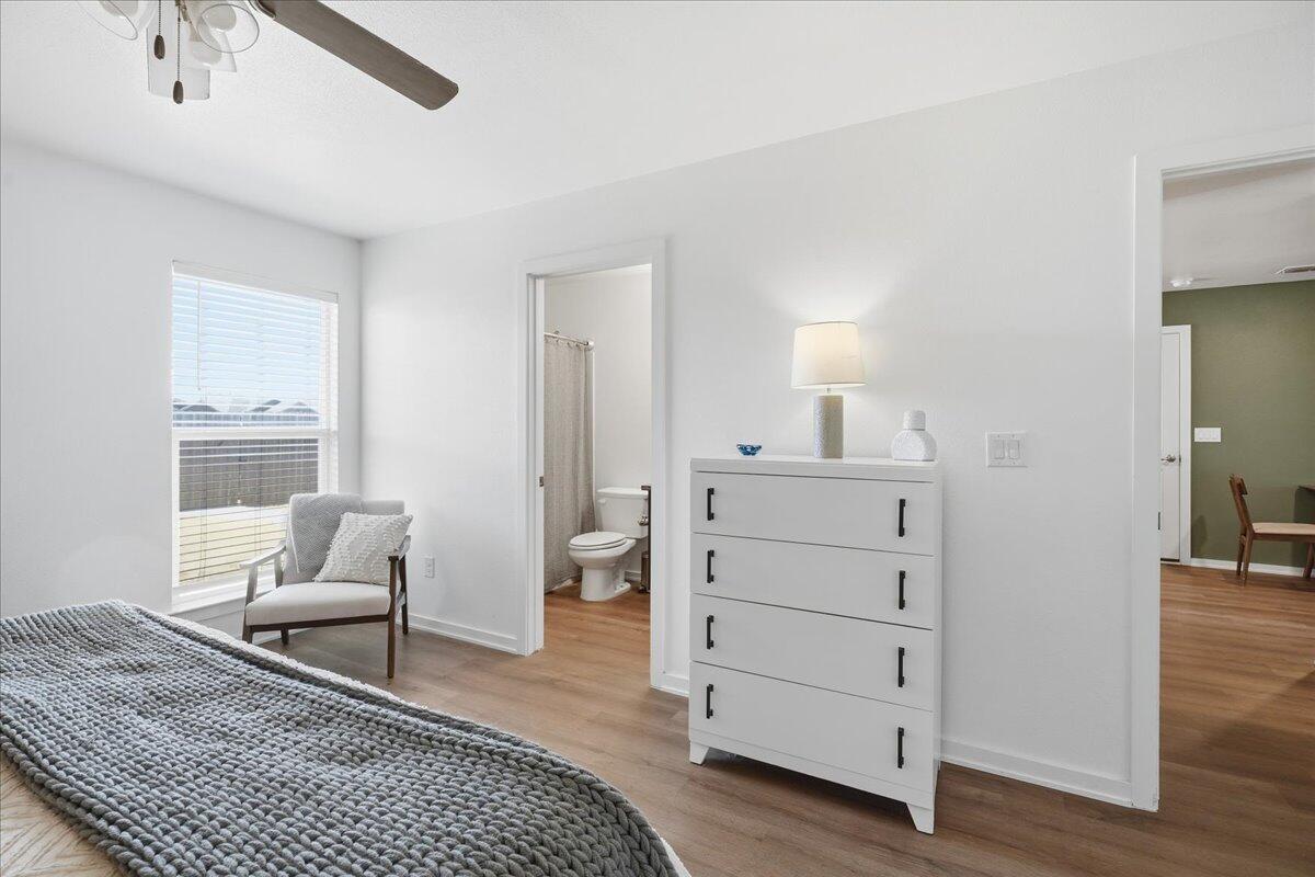 13804 Paris Avenue Lubbock, TX 79423 - Photo 14 of 28 a spacious bedroom with a bed and a chair