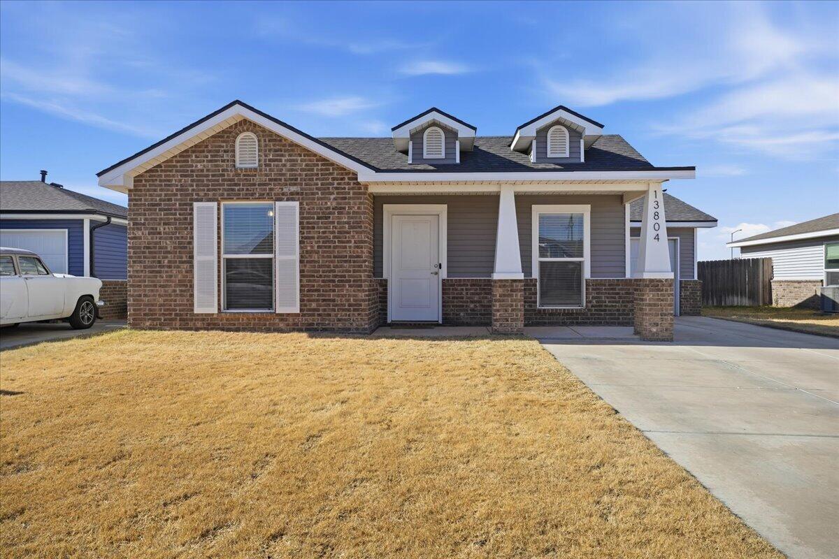 13804 Paris Avenue Lubbock, TX 79423 - Photo 2 of 28 a front view of a house with a yard