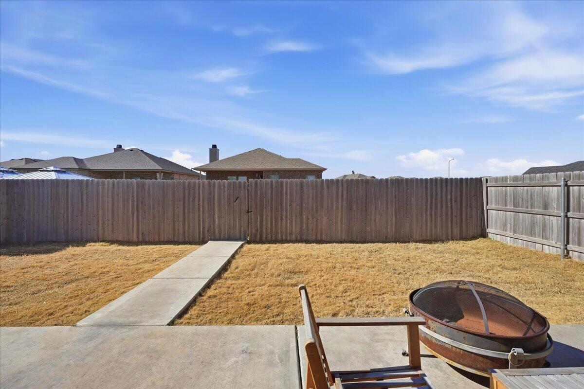 13804 Paris Avenue Lubbock, TX 79423 - Photo 24 of 28 a view of backyard with wooden fence