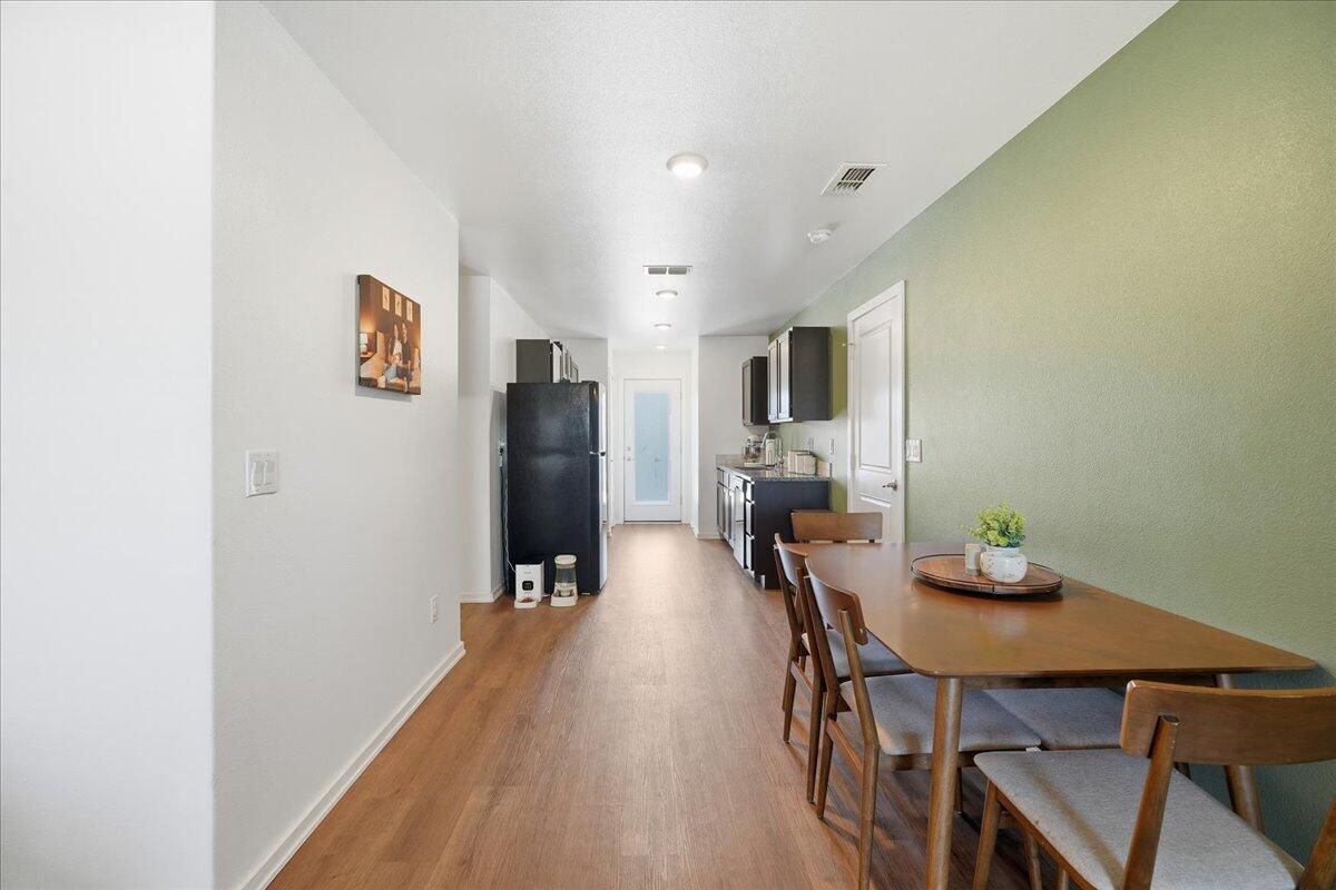 13804 Paris Avenue Lubbock, TX 79423 - Photo 6 of 28 a view of a dining room with furniture and wooden floor