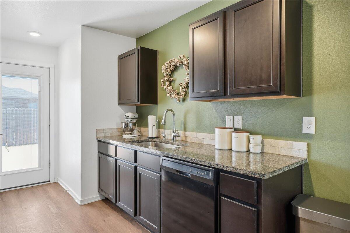 13804 Paris Avenue Lubbock, TX 79423 - Photo 9 of 28 a bathroom with a granite countertop sink and a mirror